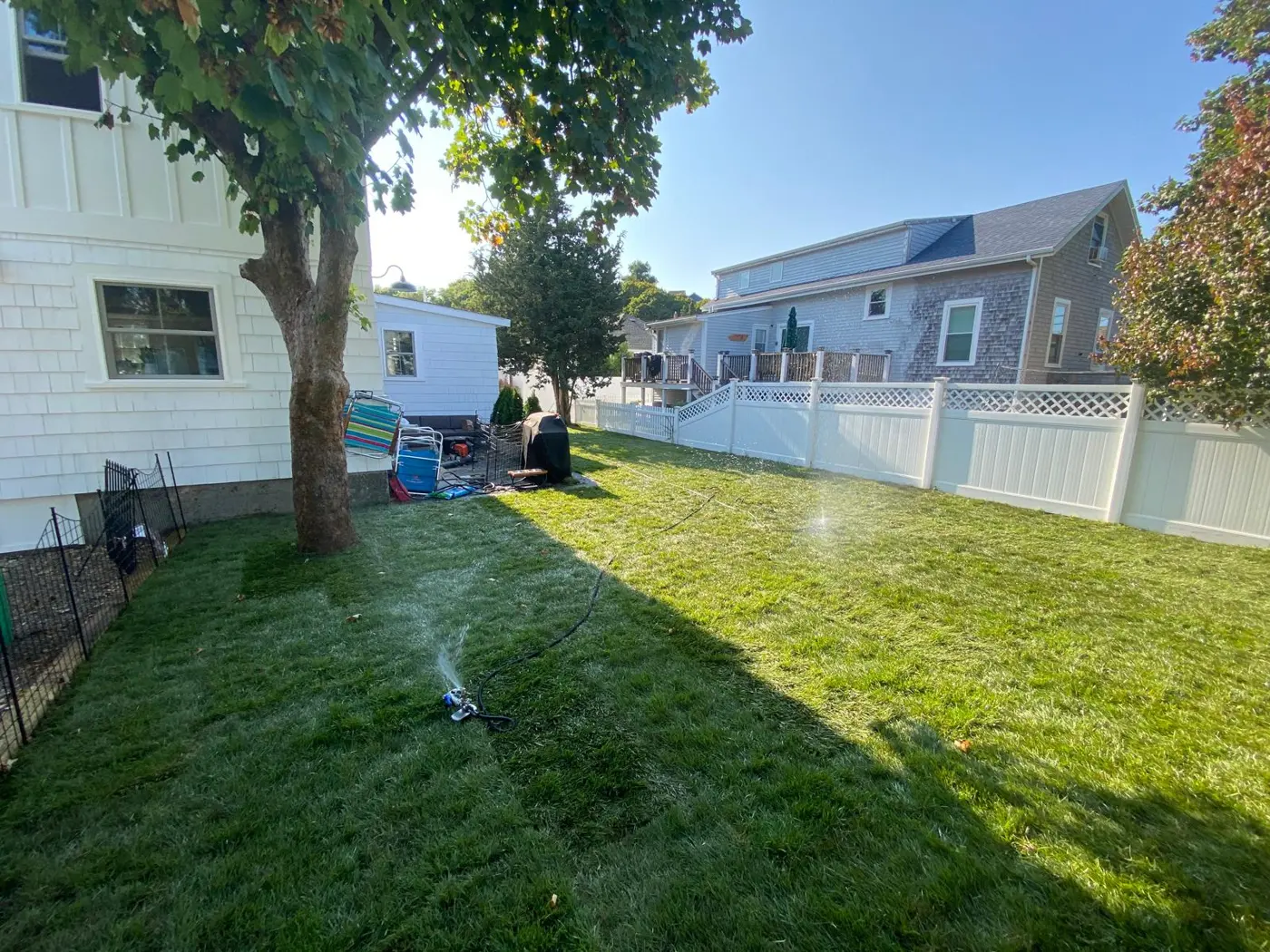 Fresh green lawn with sprinkler running