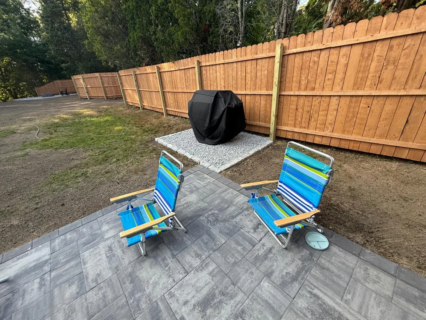 Paver patio with outdoor seating and fence