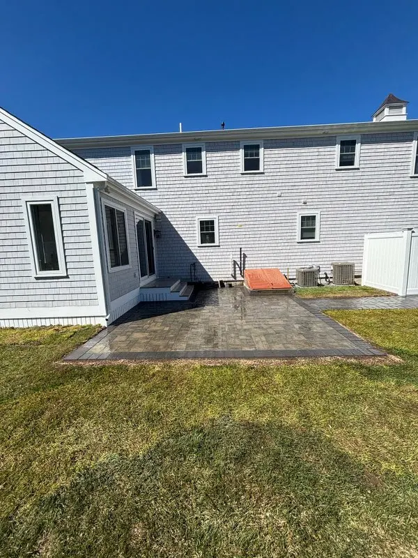 New paver patio beside a house